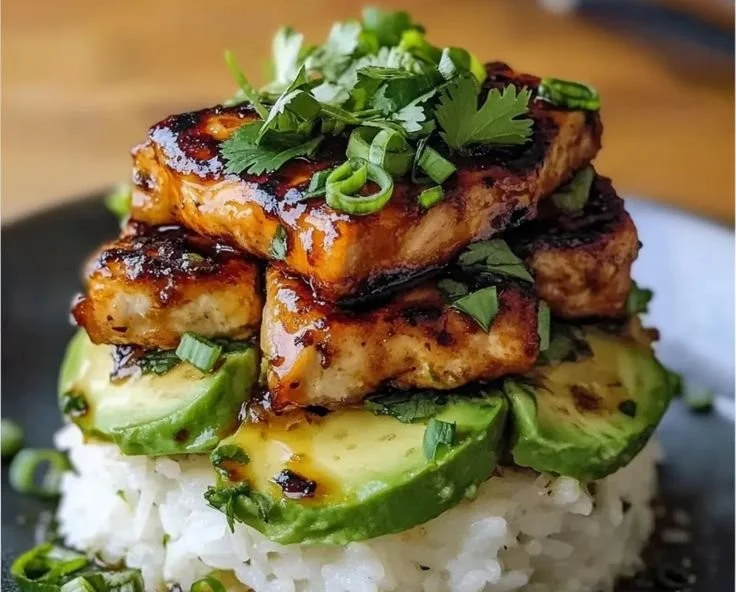 Honey Lime Chicken and Avocado Rice Stack on a plate garnished with fresh cilantro