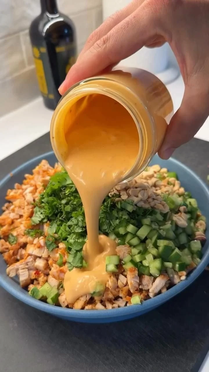 A vibrant Korean BBQ Chicken Salad garnished with fresh vegetables and sesame dressing.